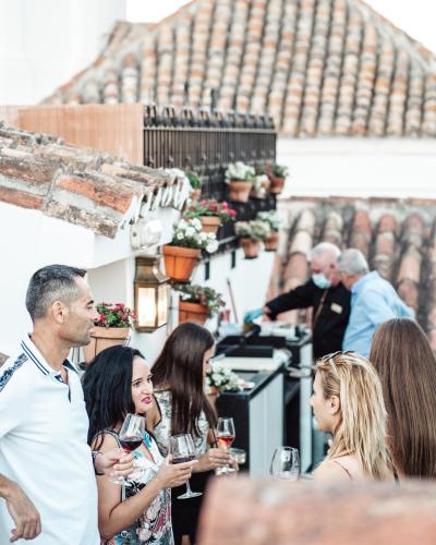 a group of people drinking wine on a patio at Hotel Claude Marbella in Marbella