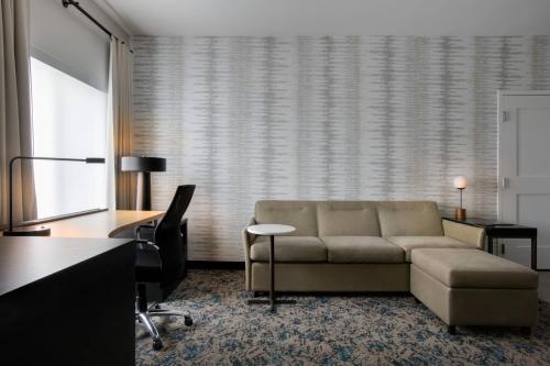 a living room with a couch and a desk at Residence Inn Waco South in Waco