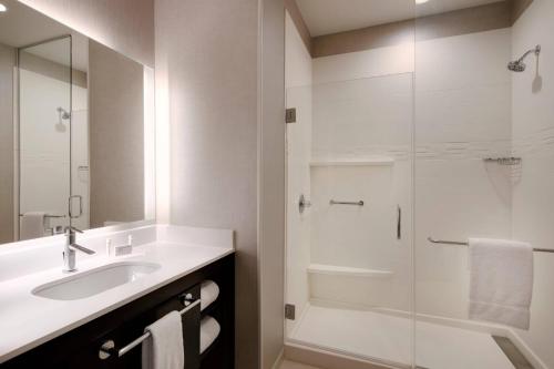 a bathroom with a sink and a glass shower at Residence Inn Waco South in Waco