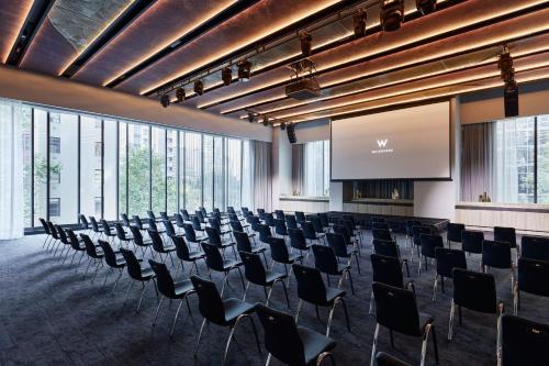 a large room with chairs and a projection screen at W Melbourne in Melbourne