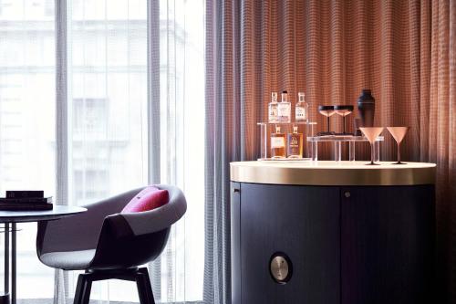 a room with a chair and a table and a counter at W Melbourne in Melbourne