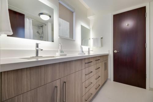a bathroom with a sink and a mirror at SpringHill Suites by Marriott Dallas NW Highway at Stemmons / I-35East in Dallas
