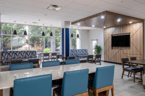 a conference room with a table and chairs and a tv at Holiday Inn Express - Gaffney by IHG in Gaffney