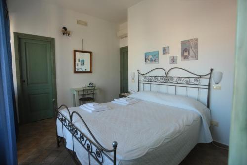 a bedroom with a white bed with two towels on it at B&B Nonna Maria in Termoli