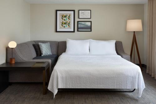 ロンドンにあるResidence Inn by Marriott London Canadaのベッドルーム(ベッド1台、ソファ付)