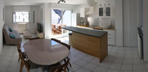 une cuisine et une salle à manger avec une table et des chaises dans l'établissement T3 Sea View with beach at 20m Saint-Marc-sur-Mer, à Saint-Nazaire