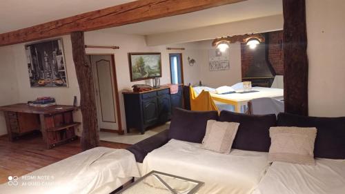 a living room with a couch and a table at Maison de ferme au calme jusqu'à 10 personnes in Gannay-sur-Loire