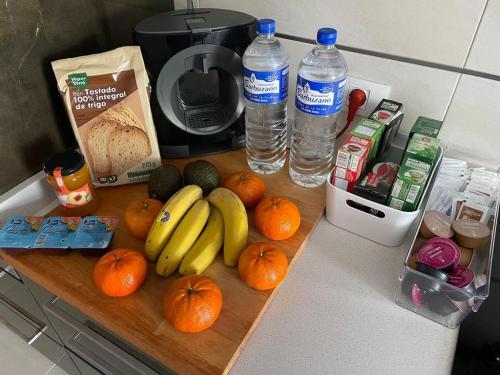 a counter top with bananas oranges and water bottles at Vivienda Ubuntu in Los Llanos de Aridane