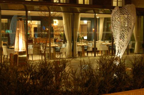 a restaurant with tables and chairs at night at Gonville Hotel in Cambridge