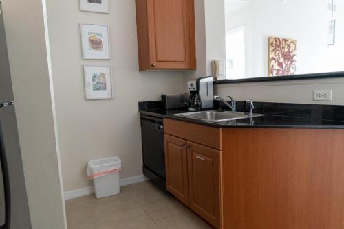 a kitchen with a sink and a counter top at The Point Hotel & Suites - 705S Luxury - Pool view - Close to Universal in Orlando