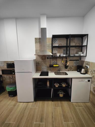 a kitchen with a white counter and a sink at Hotel Apartamentos Pueblo Mar in Calpe