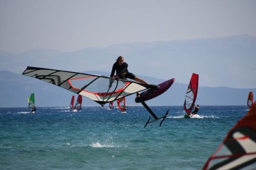 a man is on a kite in the water at Surf Hotel in Vasiliki