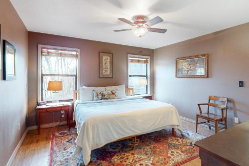 a bedroom with a bed and a ceiling fan at Lone Star Lake House in Eureka Springs
