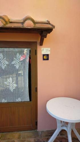 a white table and a door with a window at Casa Serena Country house in Tuscany. in Sorano