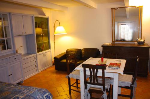 a living room with a kitchen and a table with chairs at Casa Serena Country house in Tuscany. in Sorano