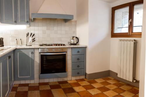a kitchen with a stove top oven next to a window at Il Mangia-Luxury in Siena
