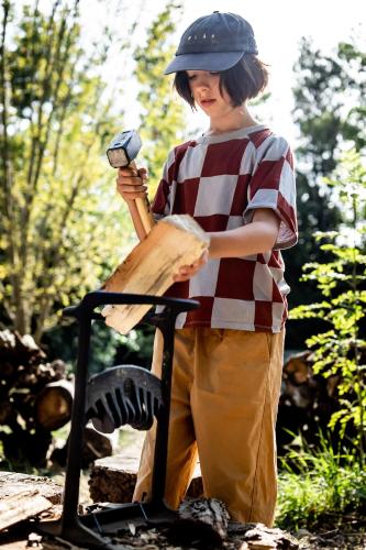 a young boy is holding a baseball bat at les Cabanes d'Ostende in Ostend