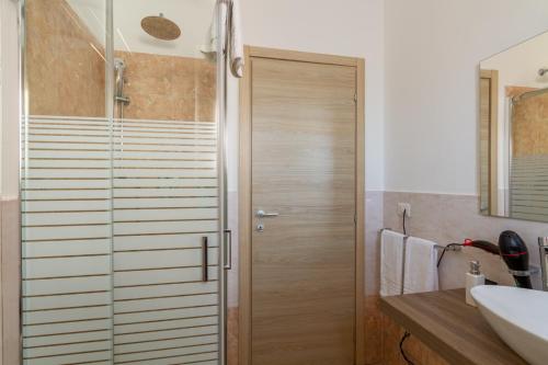 uma casa de banho com um chuveiro e uma porta de vidro em B&B Home Flowers Milano em Milão
