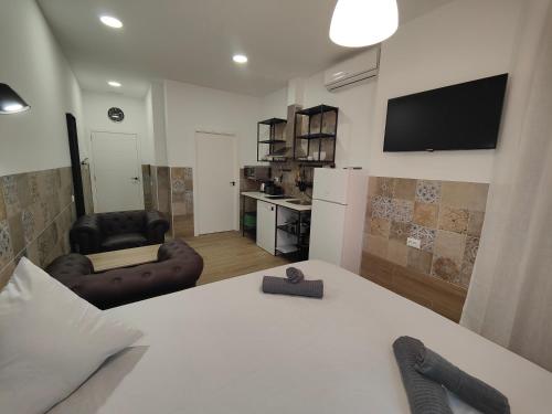 a room with a bed and a living room at Apartamentos Pueblo Mar in Calpe