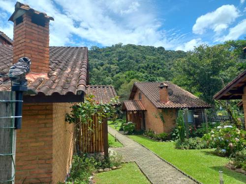 a brick house with a bird sitting on the chimney at Pousada Visconde de Mauá in Visconde De Maua