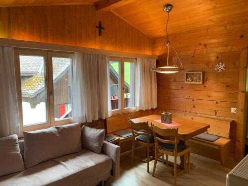 a living room with a couch and a table at Chalet Bambi in Sörenberg