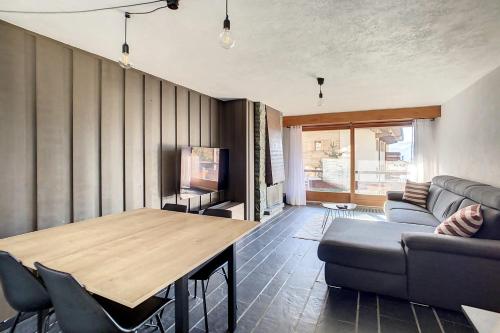 a living room with a table and a couch at Ambassador 001 in Verbier