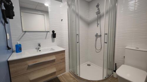 a bathroom with a shower and a sink and a toilet at Apartamentos Pueblo Mar in Calpe