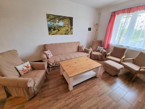 a living room with couches and a coffee table at Chalupa Bohunka in Bouzov