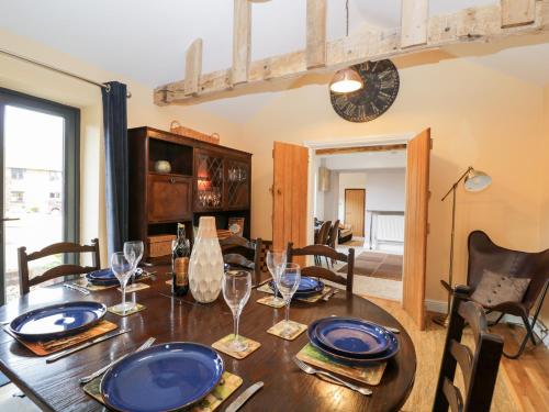 a dining room with a wooden table and chairs at The DunnitManor Farm in Salisbury