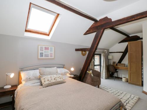 a bedroom with a large bed in a attic at The DunnitManor Farm in Salisbury