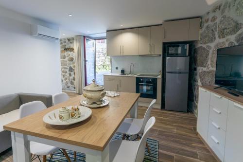 a kitchen and dining room with a table and chairs at Carvalho Village in Fafe