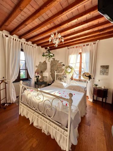 a bedroom with a white bed and a wooden ceiling at jasmine cottage in Luni