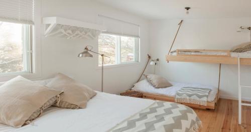 a bedroom with a bed and a bunk bed at Le Couvent Val-Morin in Val-Morin