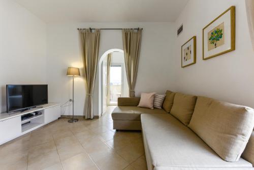 a living room with a couch and a television at Zara 2 in Kruševo