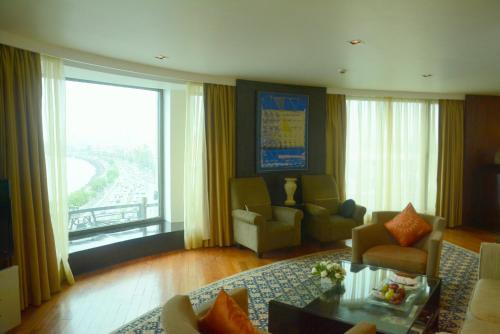 a living room with a large window with a view at InterContinental Marine Drive Mumbai by IHG in Mumbai