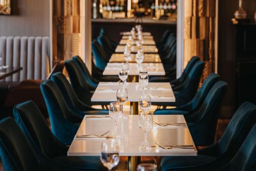 a long table in a restaurant with wine glasses on it at Bay View Hotel in Kilkee