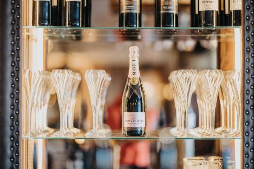 a bottle of champagne and wine glasses on a shelf at Bay View Hotel in Kilkee