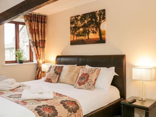 a bedroom with a bed and a window at The Hayloft at Tennant Barn in Skipton