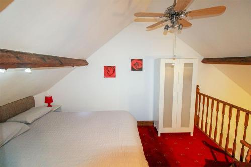 a bedroom with a bed and a ceiling fan at The Drapery, Haltwhistle in Haltwhistle