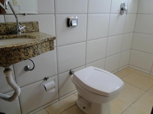 a bathroom with a toilet and a sink at Hotel Nacional in Jataí