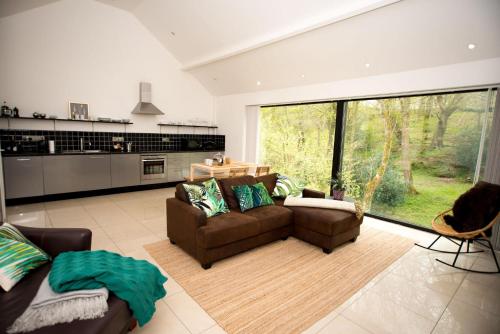 uma sala de estar com dois sofás e uma grande janela em The Heronry, Netherby, Near Carlisle em Longtown