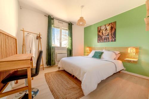 a green bedroom with a bed and a desk at ForestPlage Gîte avec SPA nordique in Cognac-la-Foret