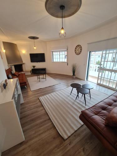 a living room with a couch and a table at Portimão Paradise - Spacious Family Villa in Portimão