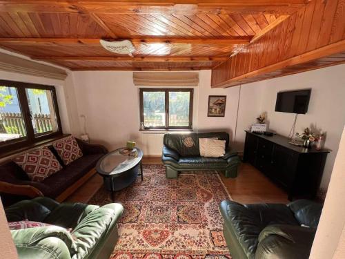 a living room with couches and a tv at Silva Cabin - In the heart of Bran, next to the Castle w/ free parking in Bran