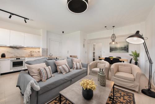 a living room with a couch and chairs and a table at Island Hills in Rhodes Town