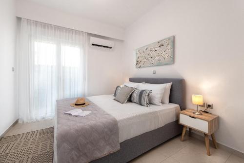a bedroom with a large bed and a window at Island Hills in Rhodes Town