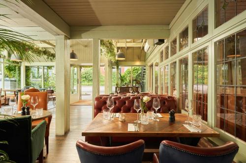a dining room with a table and chairs at Mill on the Exe in Exeter