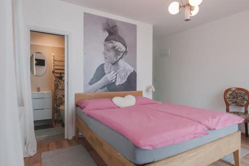 a bedroom with a bed and a picture of a woman at Kozlova Vila in Kardašova Řečice