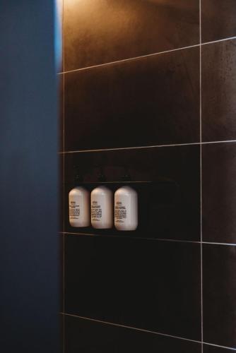 three rolls of toilet paper on a shelf in a bathroom at Drifter Studio at Basalt Luxury Accommodation in Canobolas