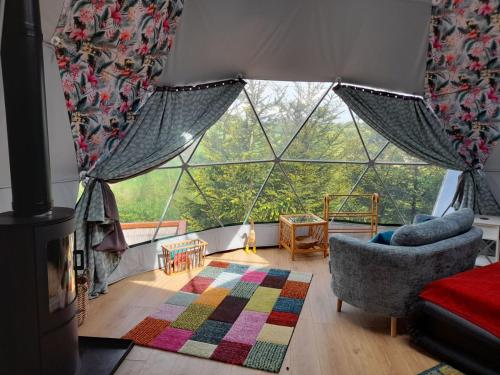 a living room with a large glass window at Norwegian Wood in Rhayader